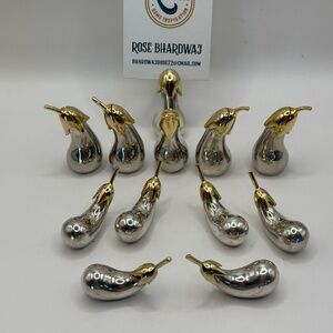 Set of 6 place card holders and 6 knife rests shaped like silver eggplants.